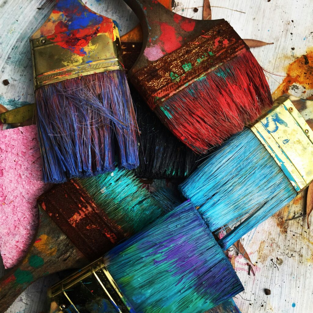 Florida Artist RhondaK paintbrushes drying. She uses colorful paint in her works on mermaids, manatees, crabs, palm trees, and more. RhondaK.art